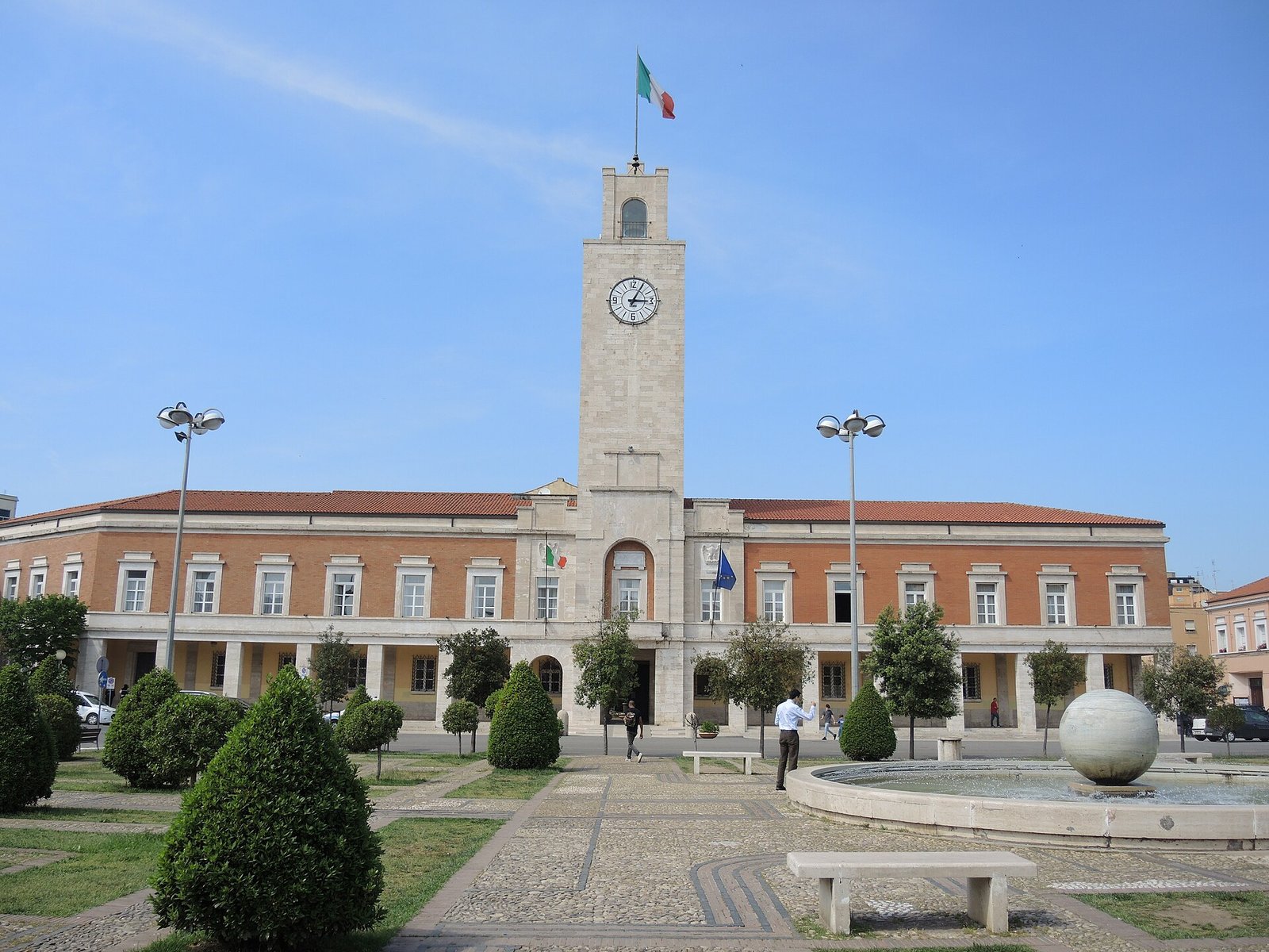 The town hall of Latina on Piazza del Popolo, with its travertine civic tower and clock rising above the brick facade