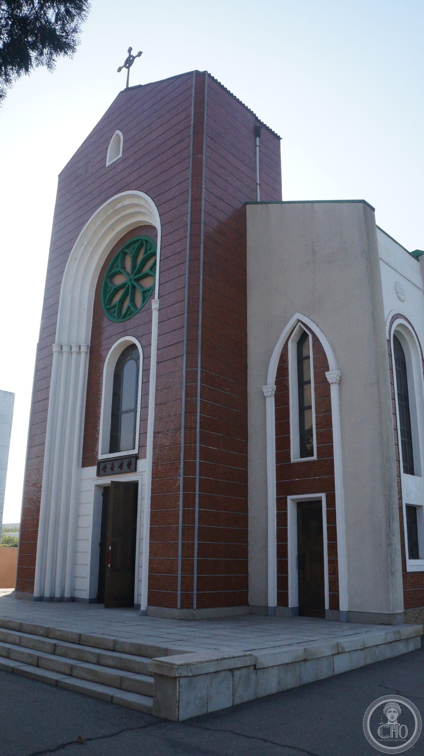 Changchung Cathedral in Pyongyang, North Korea, a red-brick church facade with a rooftop cross and Korean signage above the entrance