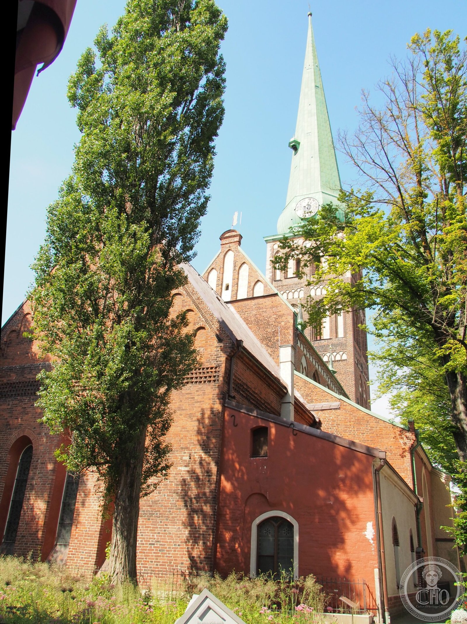 St. James's Cathedral in Riga, Latvia, a red-brick Gothic church with a single tall tower topped by a green copper needle spire