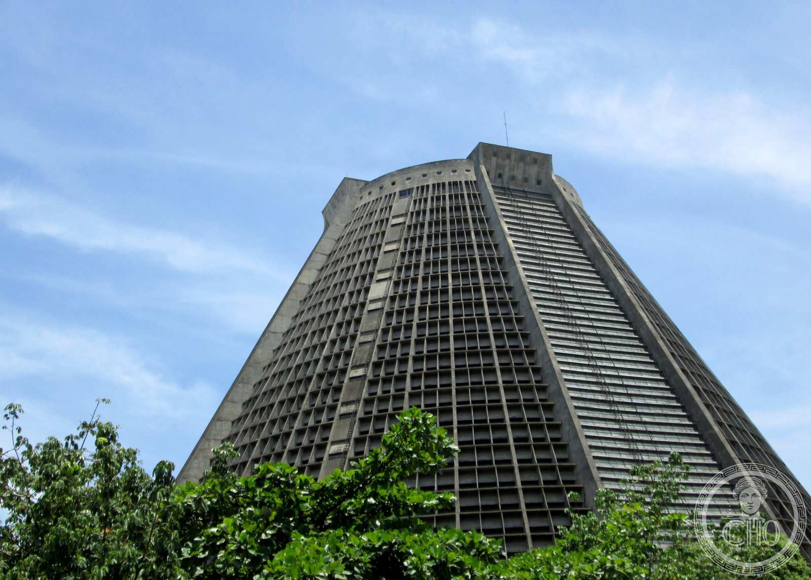 Metropolitan Cathedral of São Sebastião do Rio de Janeiro, a modernist truncated concrete cone inspired by Mayan pyramids, against a blue sky