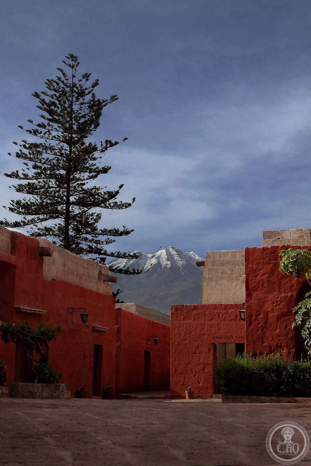 A painted street inside the Monastery of Santa Catalina in Arequipa, Peru, its walls in vivid Sevillian blue and ochre, part of a walled 20,000-square-metre citadel of cloistered life founded in 1579