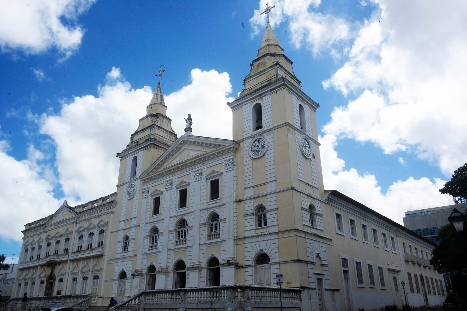 Neoclassical facade of S&atilde;o Lu&iacute;s Cathedral with twin bell towers, clocks and a pediment statue, in the historic centre of S&atilde;o Lu&iacute;s do Maranh&atilde;o