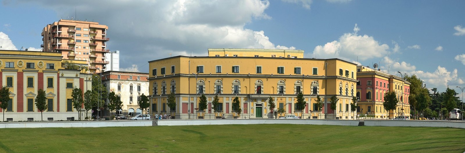 Ochre neo-Renaissance ministry buildings lining Skanderbeg Square in Tirana