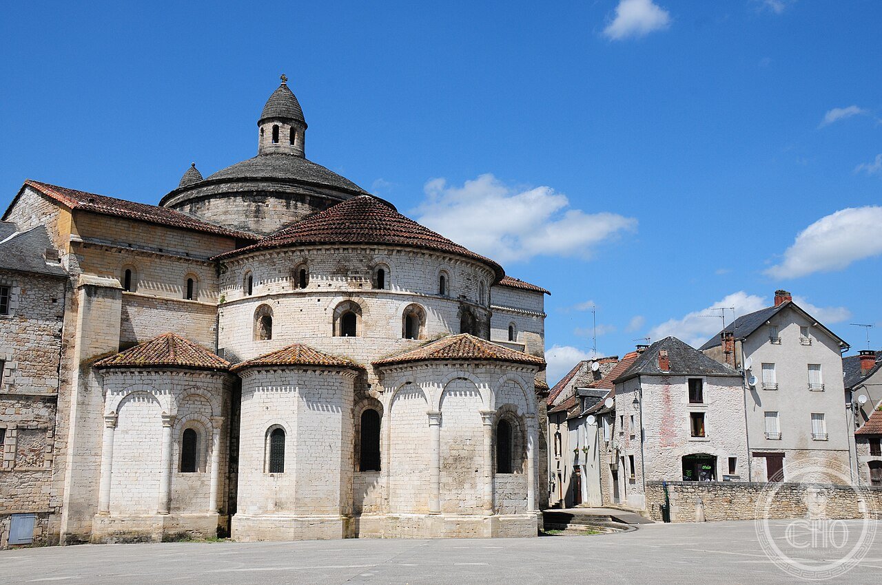 South side exterior with apse of Sainte-Marie Abbey Church, Souillac, France, completed 1145, whose Romanesque sculptures of the dancing prophet Isaiah and the Theophilus legend were saved by moving them inside during the Wars of Religion