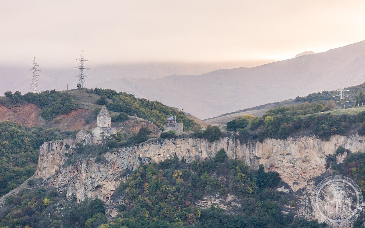 Exterior of Tatev Monastery perched on a basalt plateau above the Vorotan Gorge in Armenia, founded in the 9th century and once home to a medieval university of nearly 1,000 monks