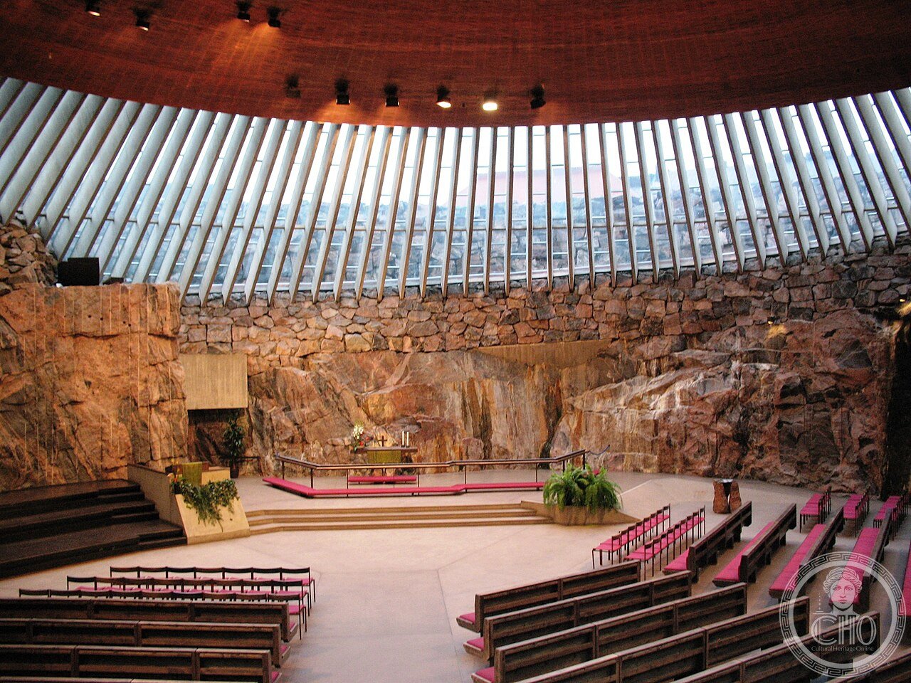 Exterior of Temppeliaukio Church in Helsinki, Finland, excavated directly into solid granite bedrock and topped with a copper dome, completed in 1969 by architect brothers Timo and Tuomo Suomalainen