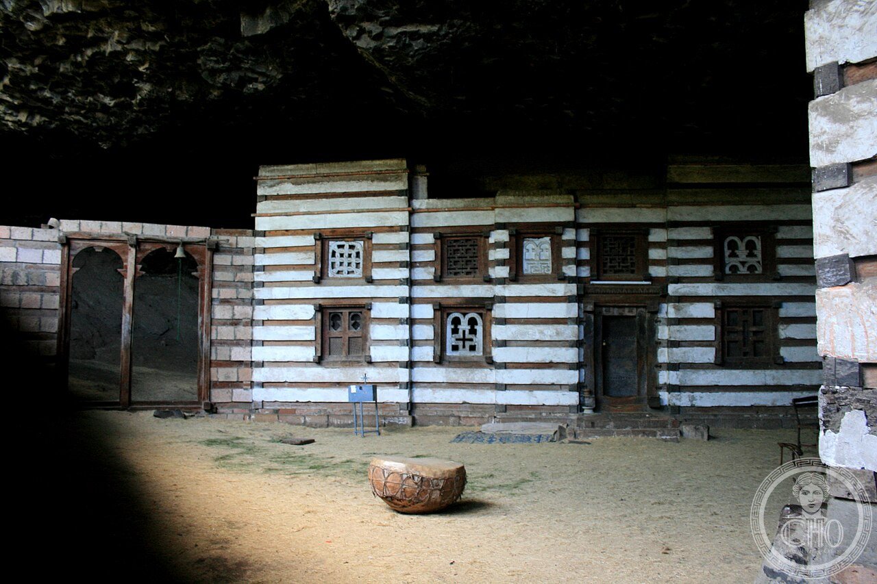 Yemrehanna Kristos church near Lalibela, Ethiopia, built entirely inside a natural cave with alternating layers of wood and stone in Aksumite style, predating the rock-hewn churches of Lalibela