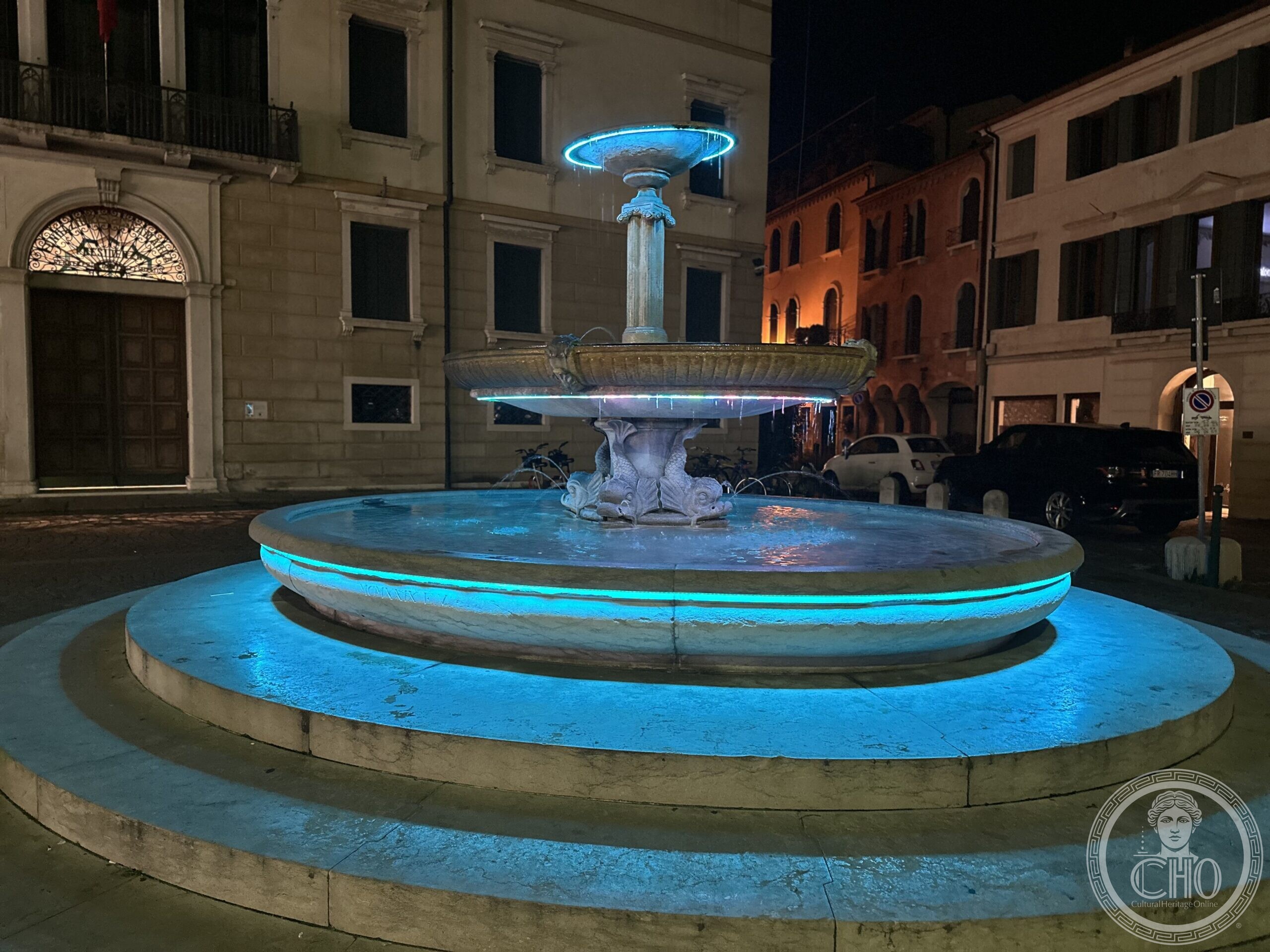 The fountain of Piazza San Leonardo in Treviso at night, lit with blue LED lighting
