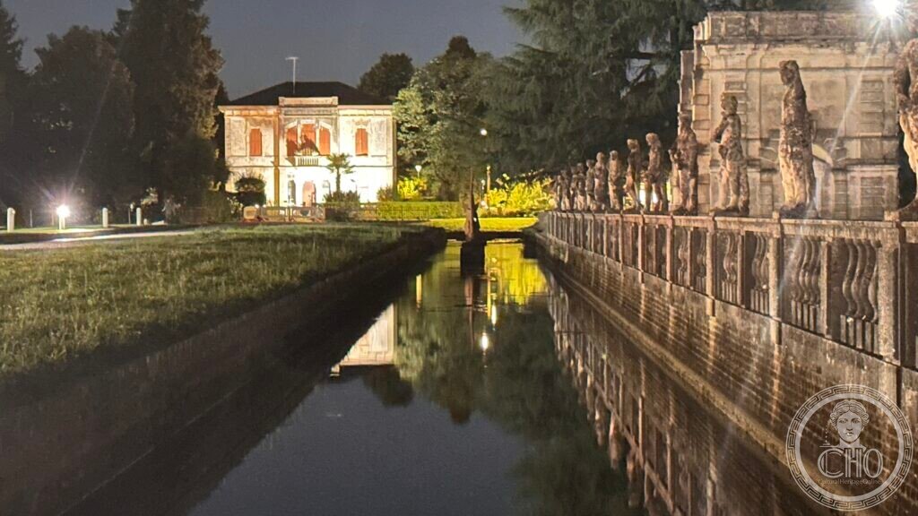 The villa seen at night across the canal from the balustraded terrace of Villa Contarini