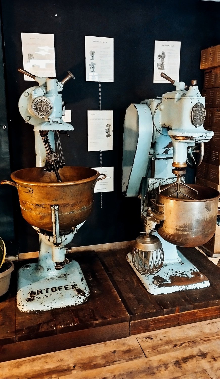 Two Artofex mixers side by side, one with a brass bowl and one with a steel bowl