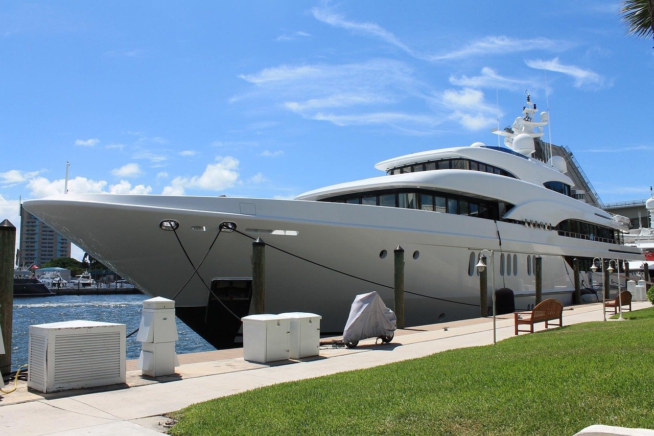 A large motor yacht moored alongside a marina quay