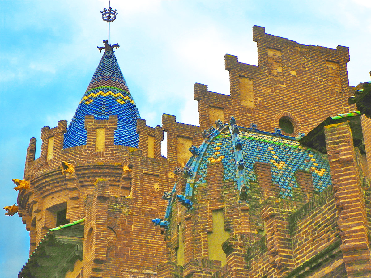 The brick mansion of Casa Roura with its conical ceramic-clad corner tower in Canet de Mar