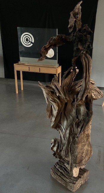 Sculpture in assembled wood, with sinuous shapes resembling a bird in flight