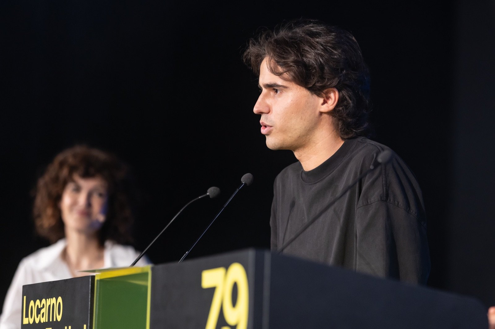 Marco Cavazzin speaking at the lectern during the Pardi di domani award ceremony at the 79th Locarno Film Festival