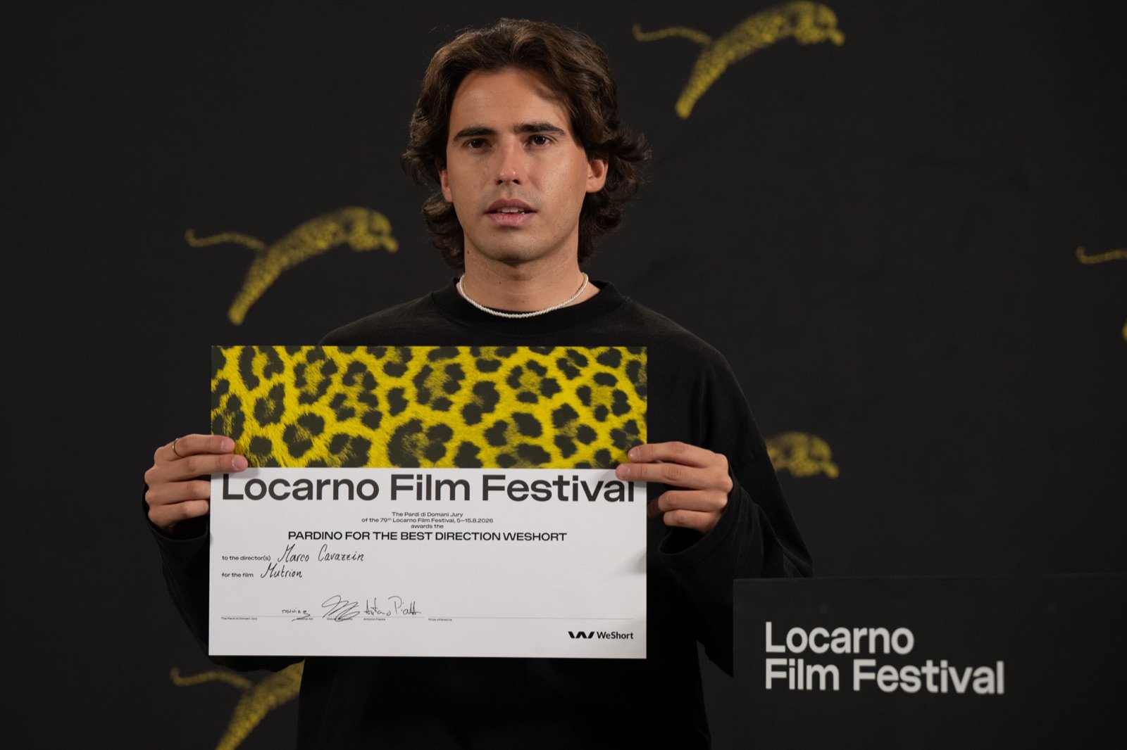 Marco Cavazzin holding the Locarno Film Festival certificate for the Pardino for the Best Direction WeShort