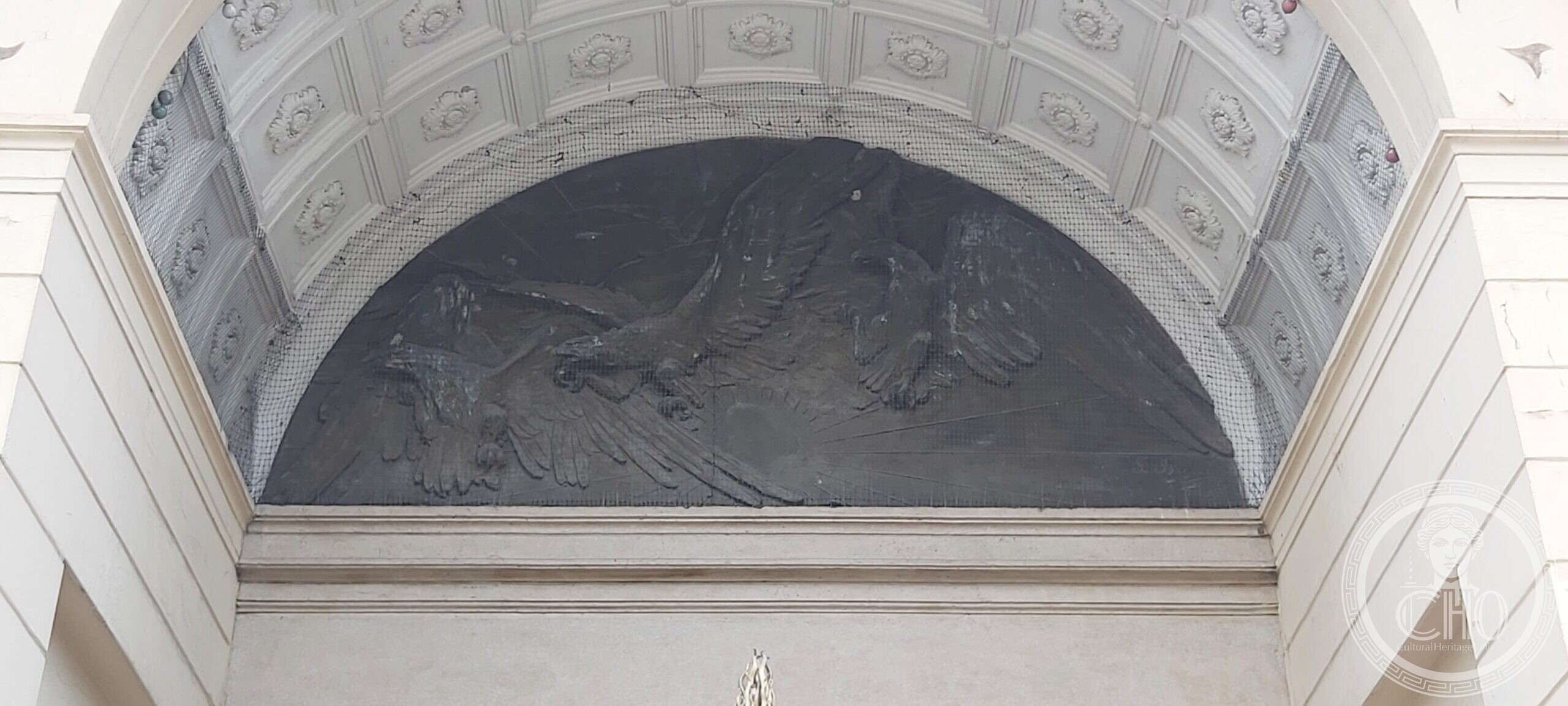 Bronze relief of wounded eagles in flight in the lunette above the entrance atrium of the Casa del Mutilato in Padua