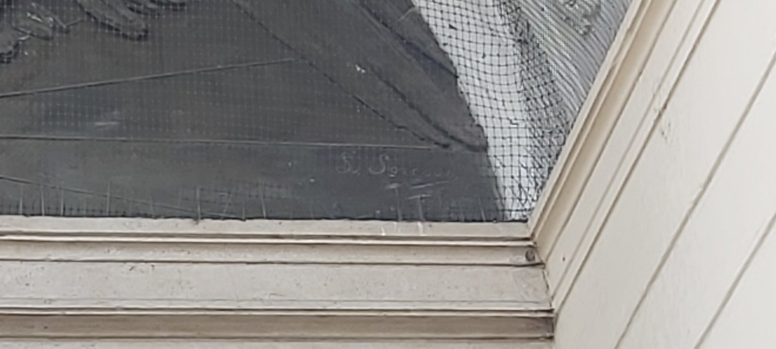 The sculptor's incised signature at the lower edge of the bronze lunette, Casa del Mutilato, Padua