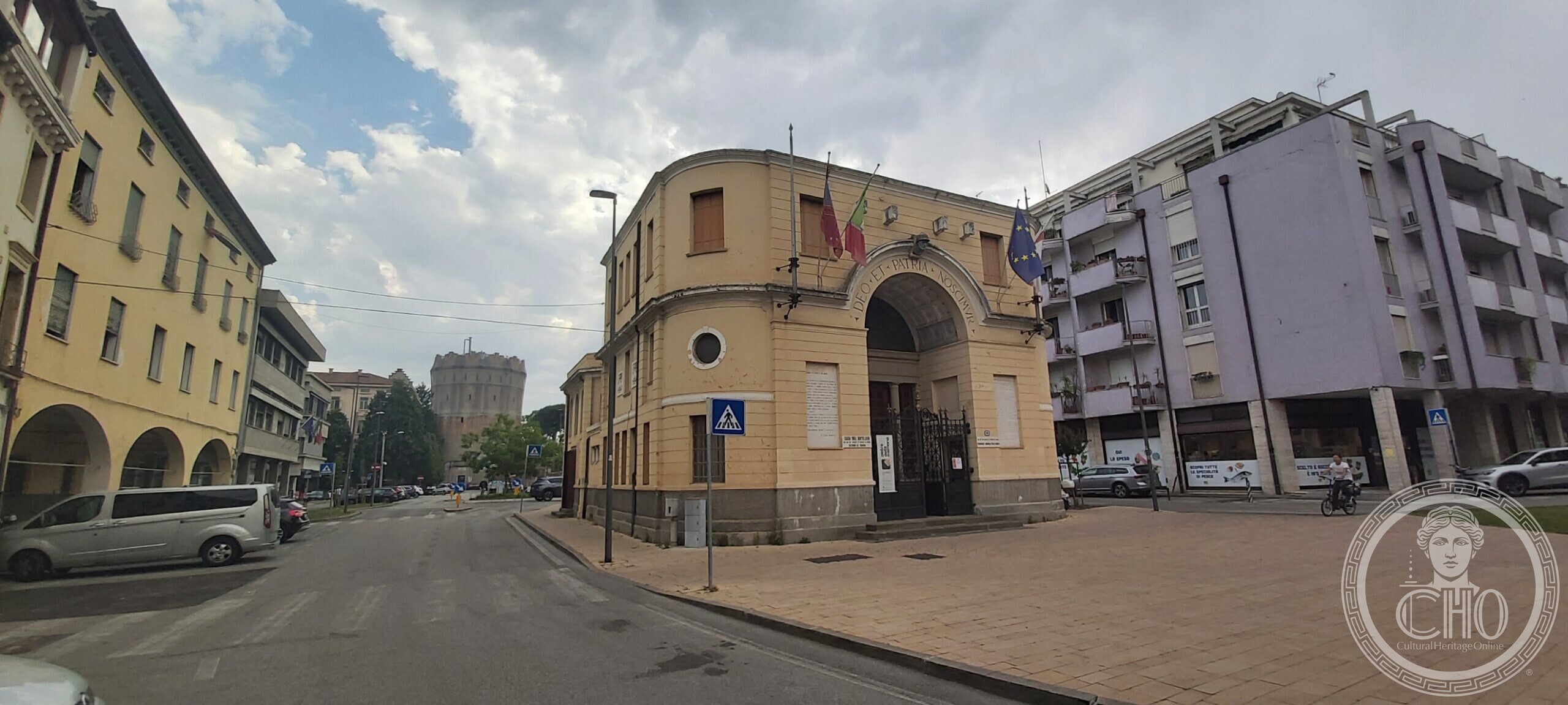 The Casa del Mutilato in Padua seen from the side, with the crenellated Rotonda water tower rising behind it