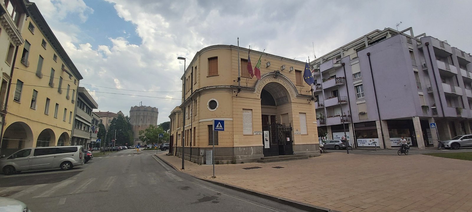 The Casa del Mutilato in Padua seen from the side, with the crenellated Rotonda water tower rising behind it