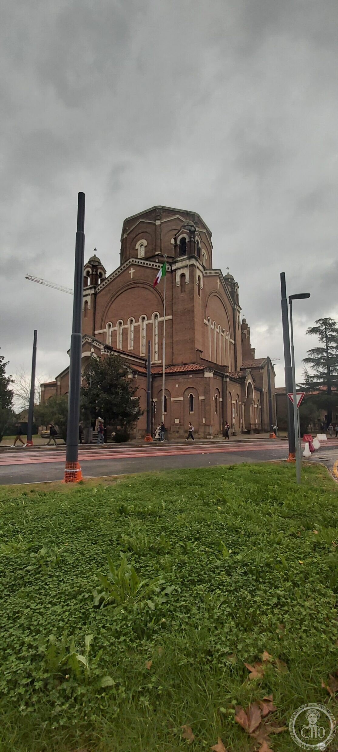 The Tempio della Pace seen from the side, showing the flank, the lantern and the corner bell towers above the trees