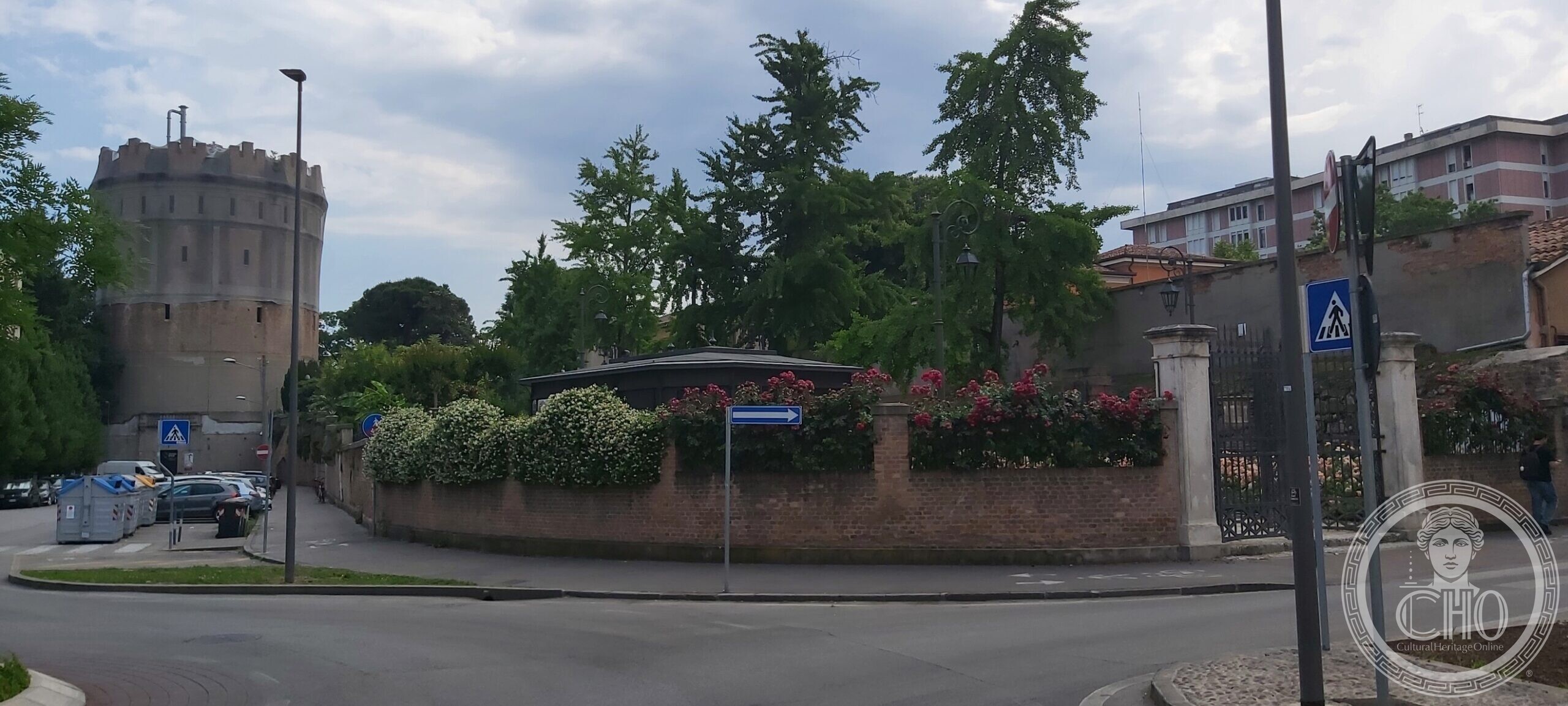 The Rotonda water tower in Padua rising above the garden wall at the street corner