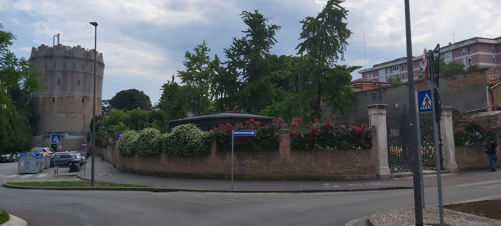 The Rotonda water tower in Padua rising above the garden wall at the street corner