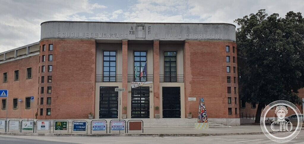 The three tall windows and central staircase of the Corridoni school in Fano