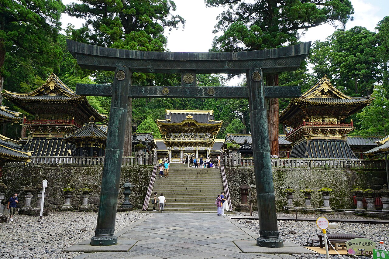 The Yōmeimon Gate at Nikkō Tōshō-gū shrine in Tochigi prefecture, Japan — an elaborately carved gate with more than 500 sculptural decorations including cranes, dragons, lions, and Chinese sages, deliberately left with one pillar inverted to avoid divine punishment for perfection