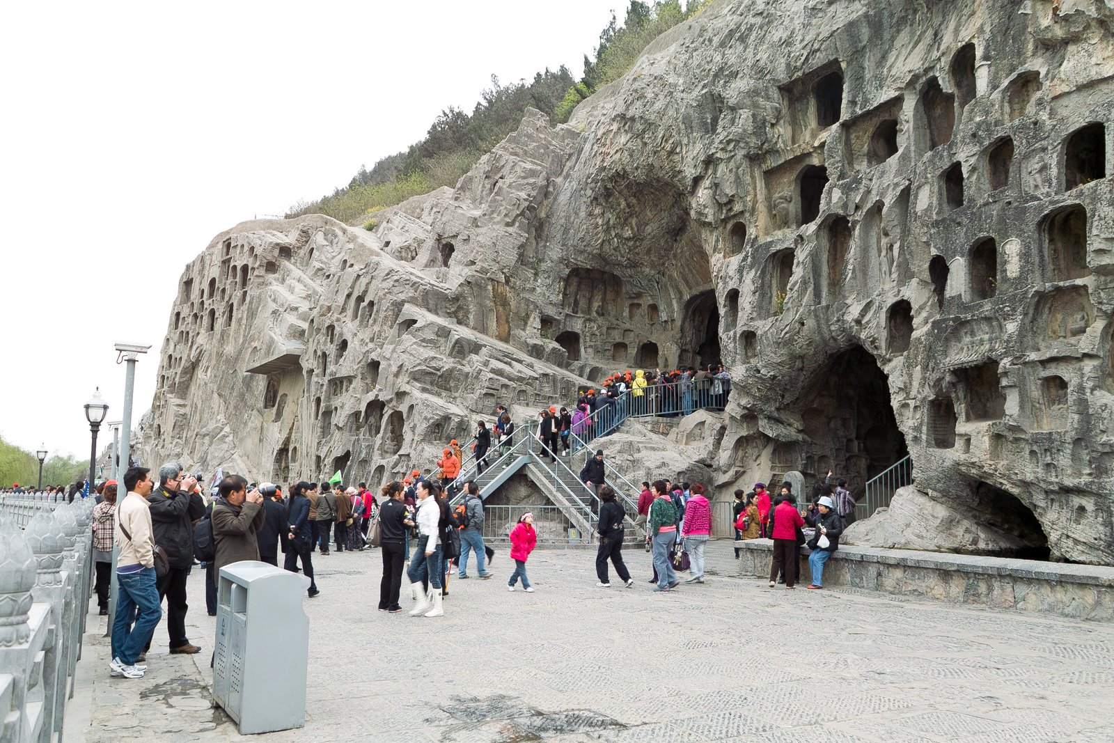 Carved Buddhist niches and sculptures in the limestone cliffs of Longmen Grottoes, Luoyang