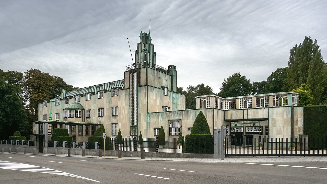 Stoclet Palace exterior in Brussels, Belgium — a 1911 Vienna Secession mansion by Josef Hoffmann with white marble cladding and gilded geometric ornamentation
