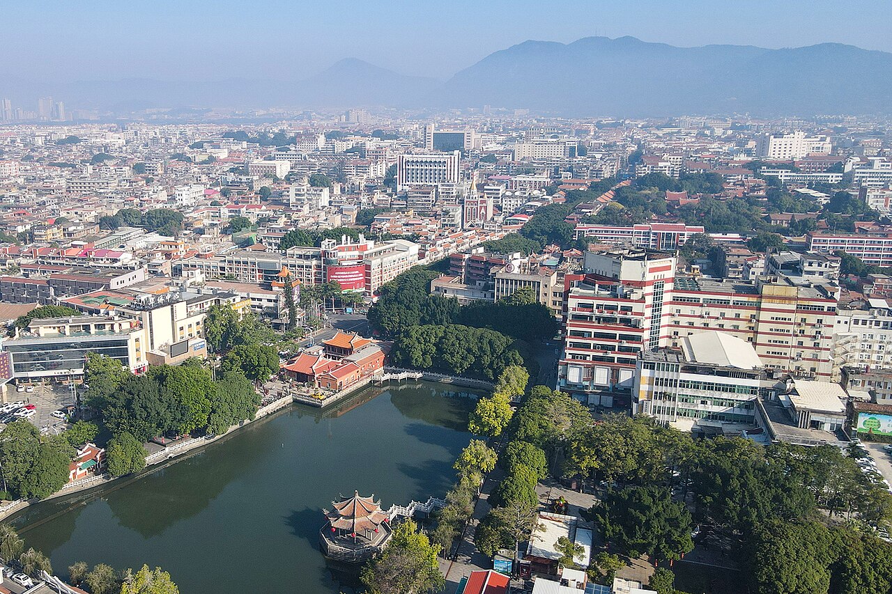 The old city waterfront of Quanzhou (Zayton), Fujian Province, China, showing the traditional Minnan red-brick commercial architecture and the Quanzhou Bay estuary — the medieval maritime trade port that Marco Polo described as one of the two greatest ports in the world, now inscribed as a UNESCO World Heritage serial site