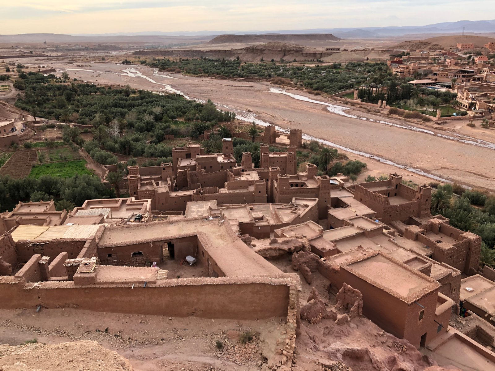 Tiered earthen towers of Ait Benhaddou ksar rising above the Ounila River valley