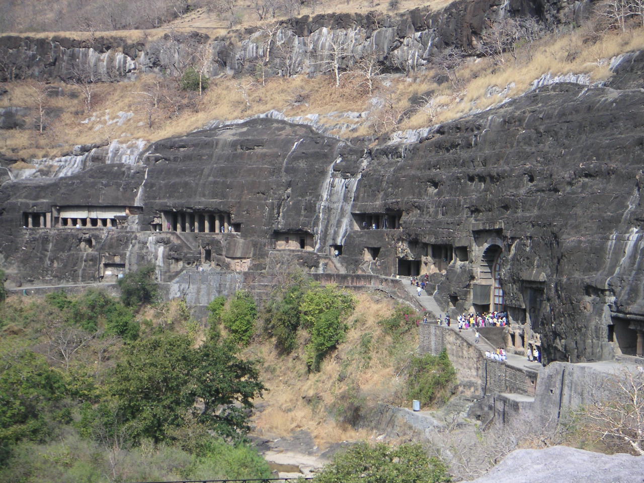 The Buddhist cave monasteries at Ajanta, Maharashtra, India — a horseshoe-shaped rock face with 29 cave entrances above the Waghora River gorge, 2nd century BCE to 6th century CE