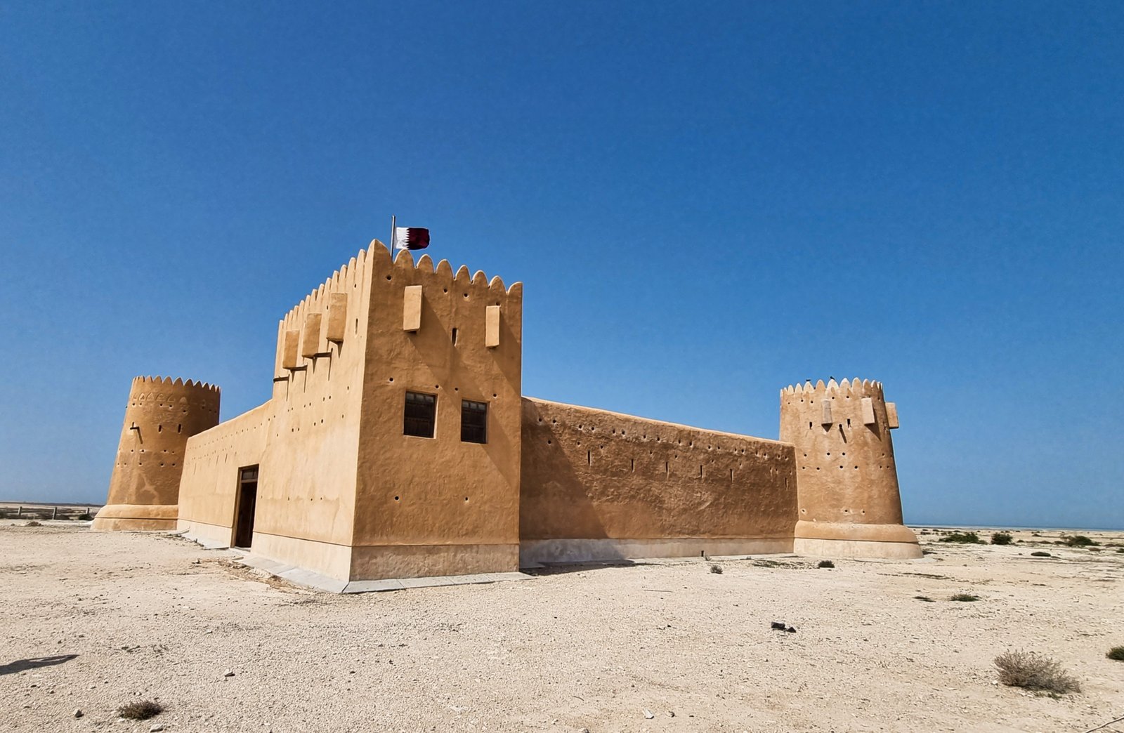 Al Zubarah Fort with its corner towers rising from the flat desert, Qatar