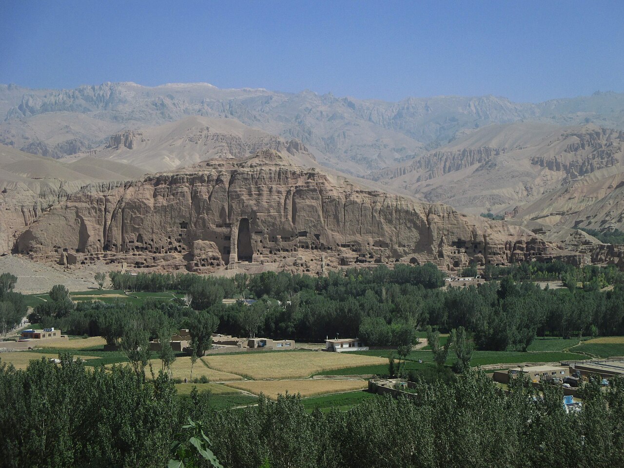 The Bamiyan Valley landscape showing the sandstone cliffs with the empty niches where the two large Buddha statues stood before their destruction in 2001, Bamiyan Province, Afghanistan