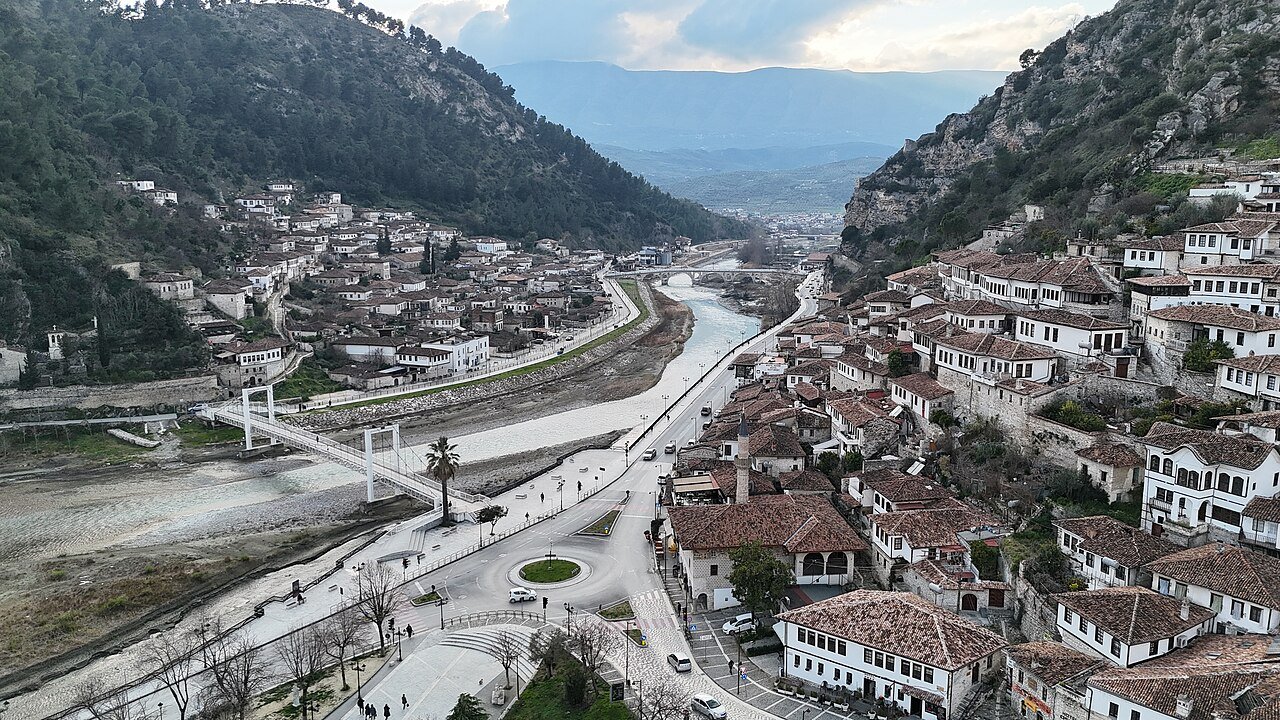 The Ottoman whitewashed houses of Berat, Albania, stacked on the hillside above the Osum River gorge with many large windows