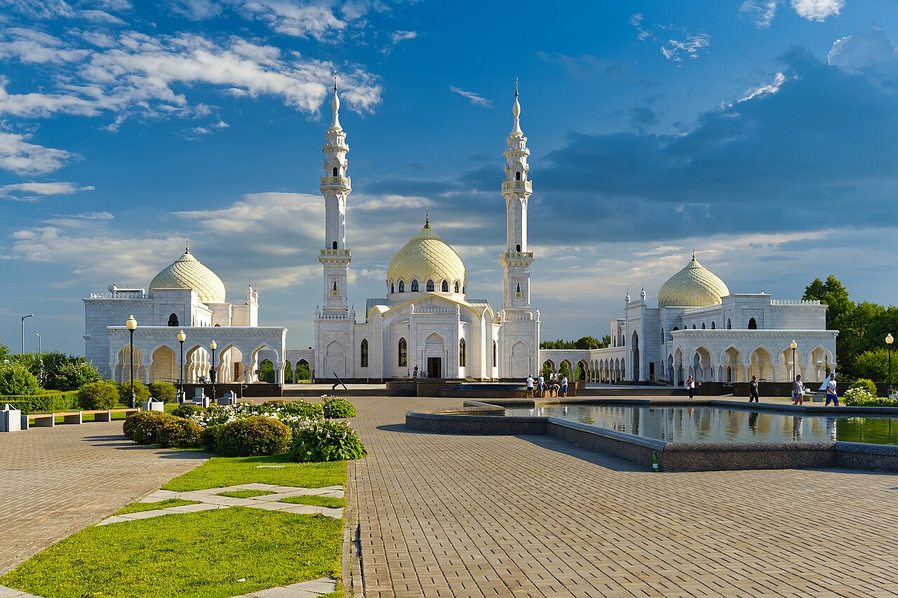 White Mosque of Bolgar with tall minaret reflecting on calm water