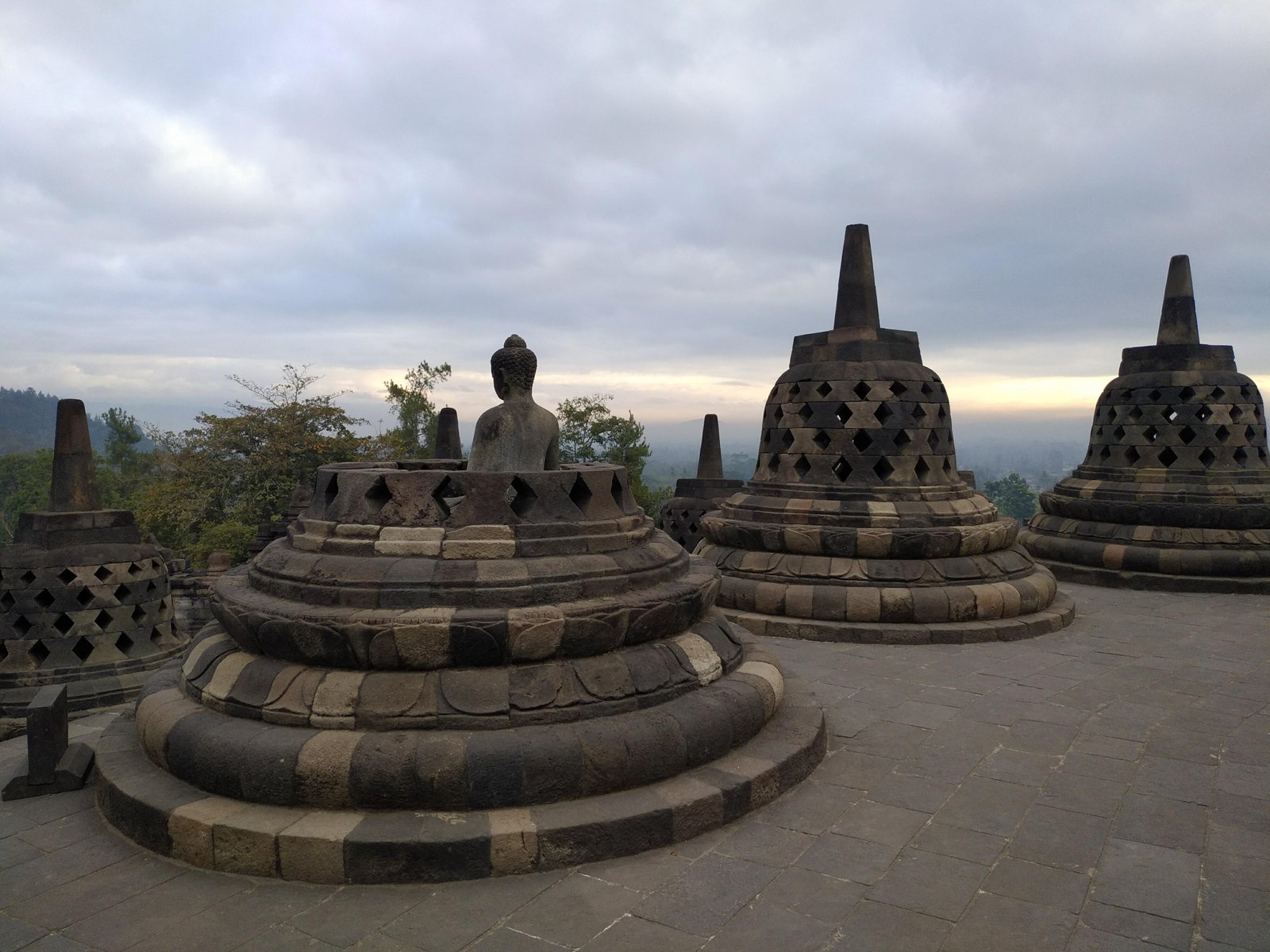 Borobudur temple terraces with stupas rising against a blue sky, Central Java