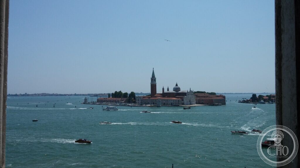 The island of San Giorgio Maggiore framed between the stone jambs of an opening high above the water