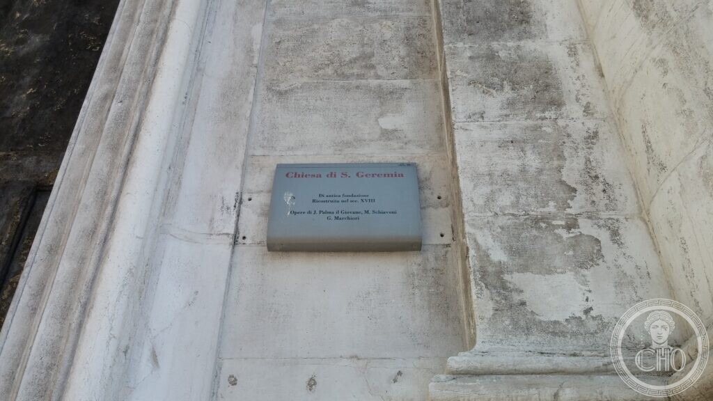 A grey stone plaque set into the pale stone front of San Geremia in Venice, reading Chiesa di S. Geremia, di antica fondazione, ricostruita nel sec. XVIII