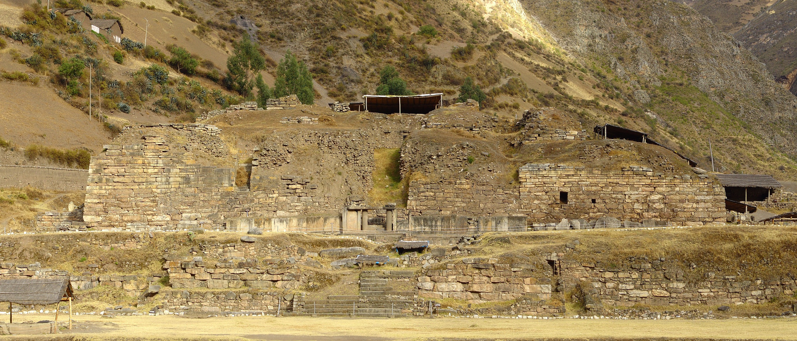 Stone temple platform of Chavín de Huántar rising against Andean mountains