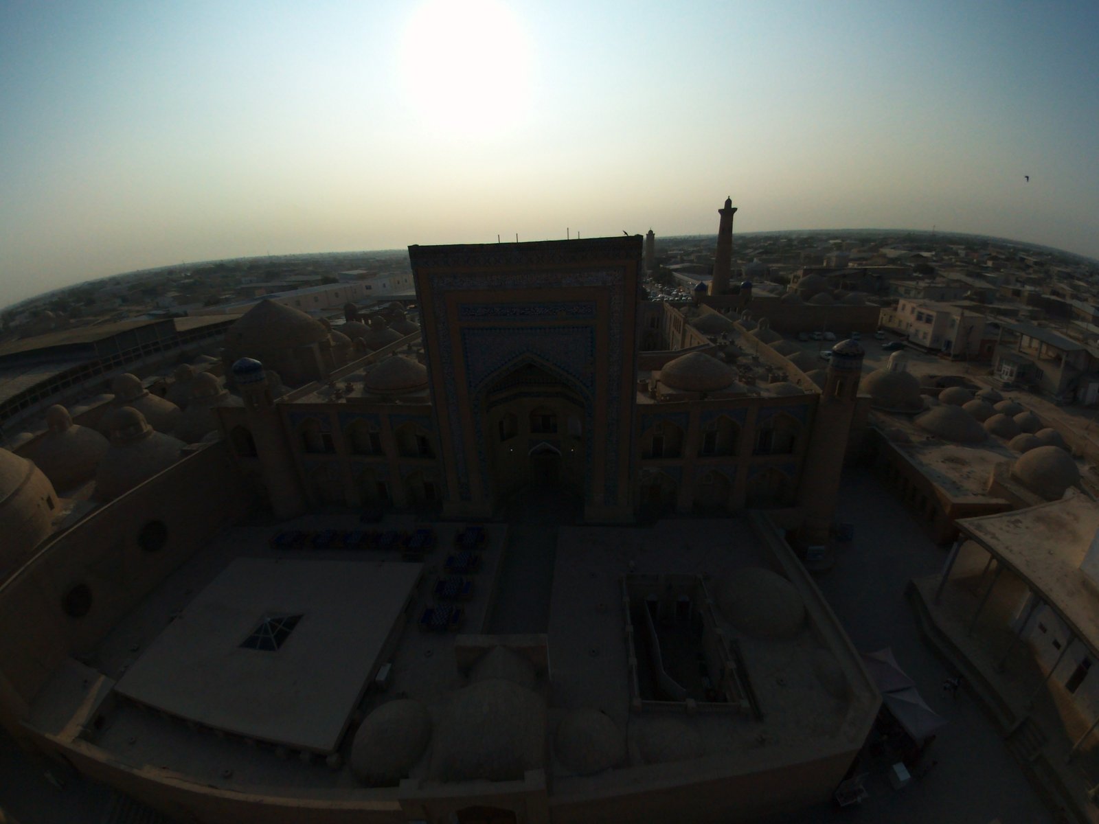 Aerial view over the walled inner city of Khiva with minarets and domed mosques at dusk