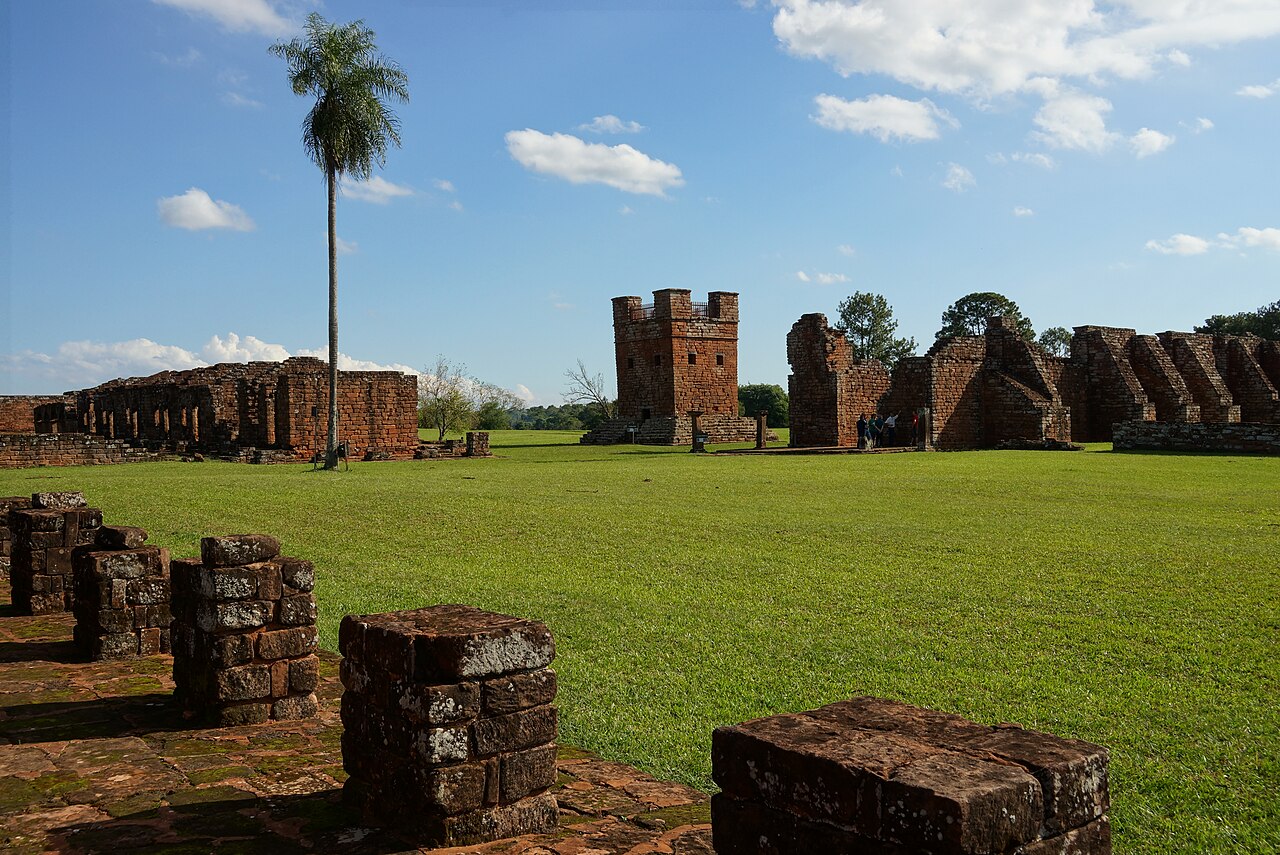 Stone bell tower of the Jesuit mission of Trinidad rising against blue sky Paraguay