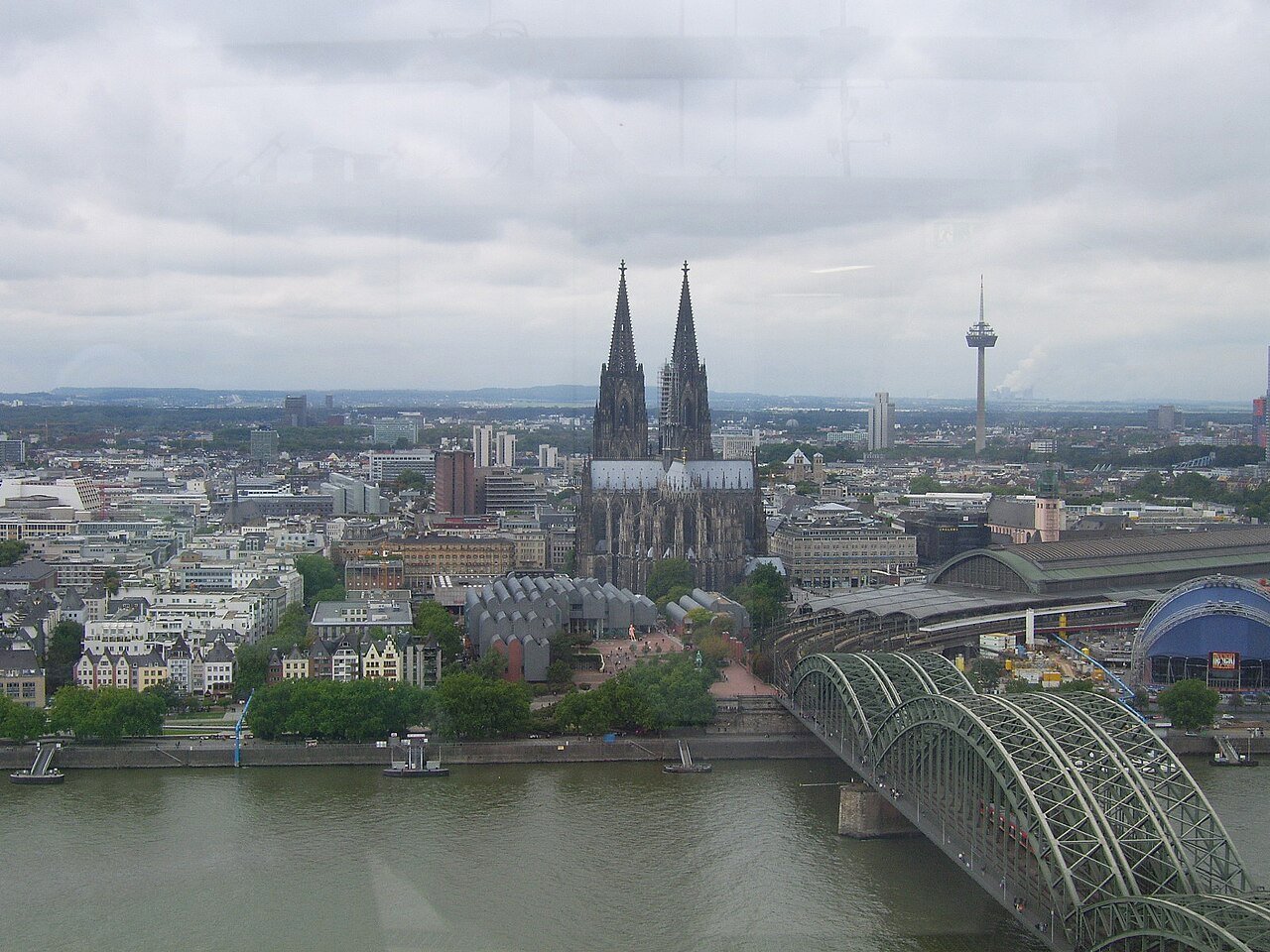 Cologne Cathedral's twin Gothic spires rising above the Rhine riverbank, the tallest Gothic spires in the world at completion
