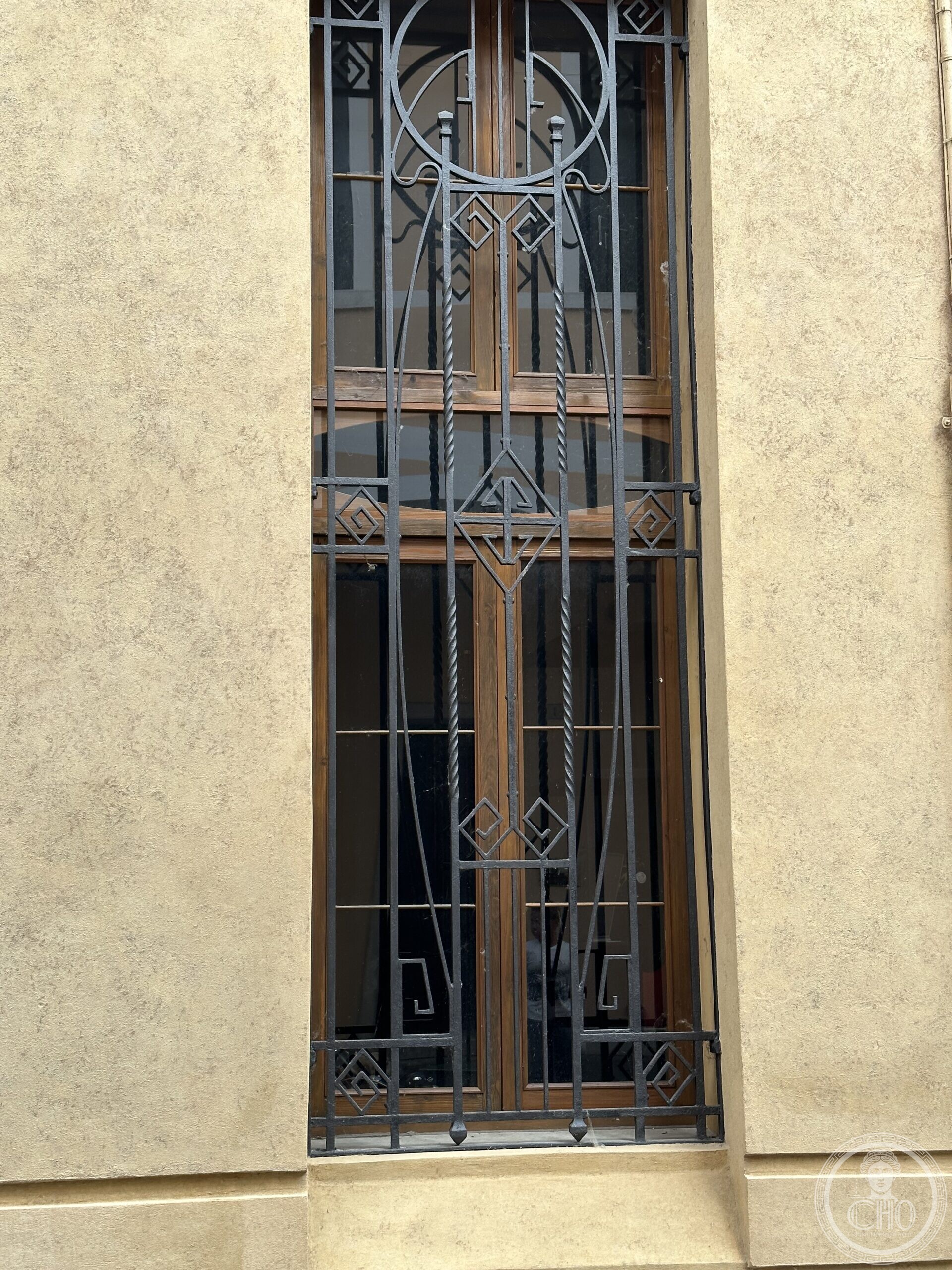 An Art Nouveau wrought-iron window grille on Via Calmaggiore, Treviso, with geometric circle and diamond motifs