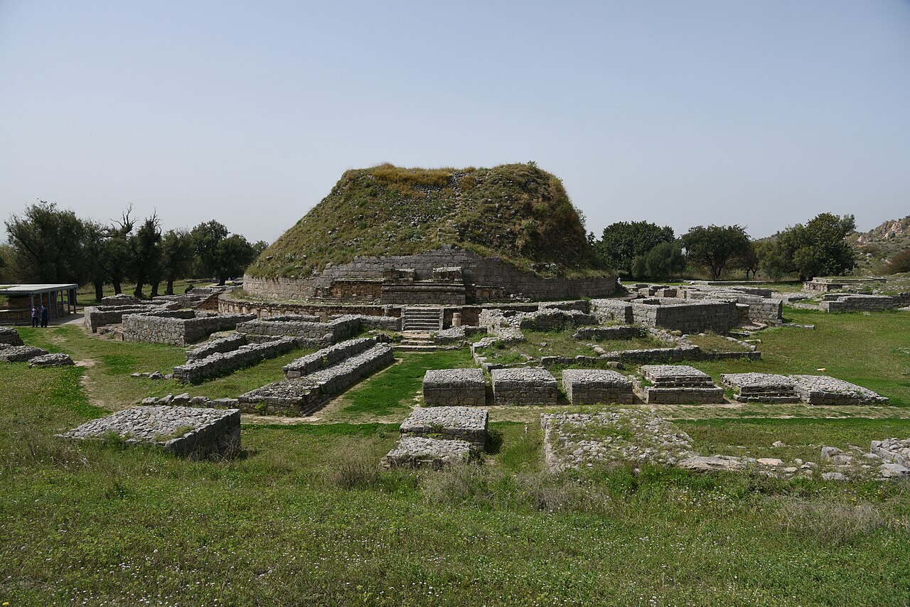 Dharmarajika Stupa and monastery ruins with green hills behind in Taxila