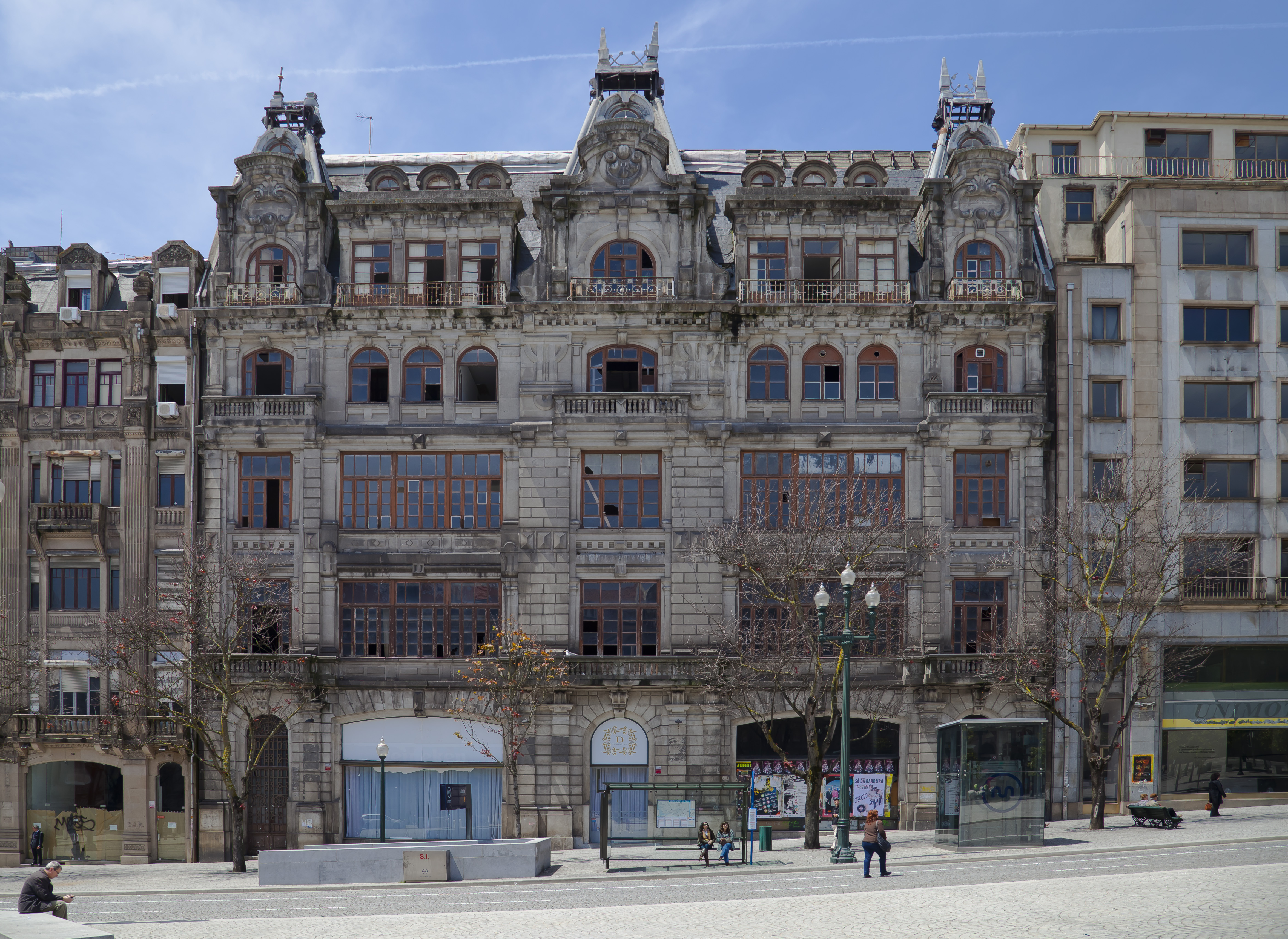 The ornate façade and mansard roof of the Monumental Palace on Avenida dos Aliados in Porto