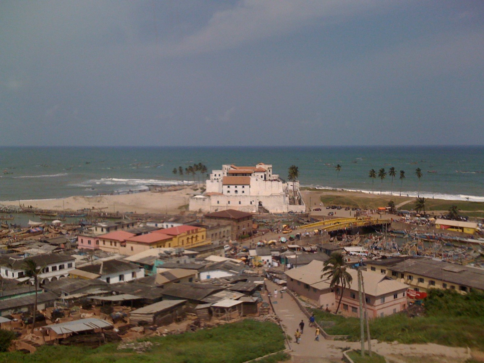 White-washed walls of Elmina Castle overlooking the Atlantic Ocean from a hilltop