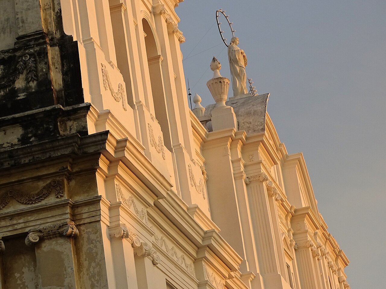 León Cathedral pale yellow baroque facade glowing at sunset, Nicaragua