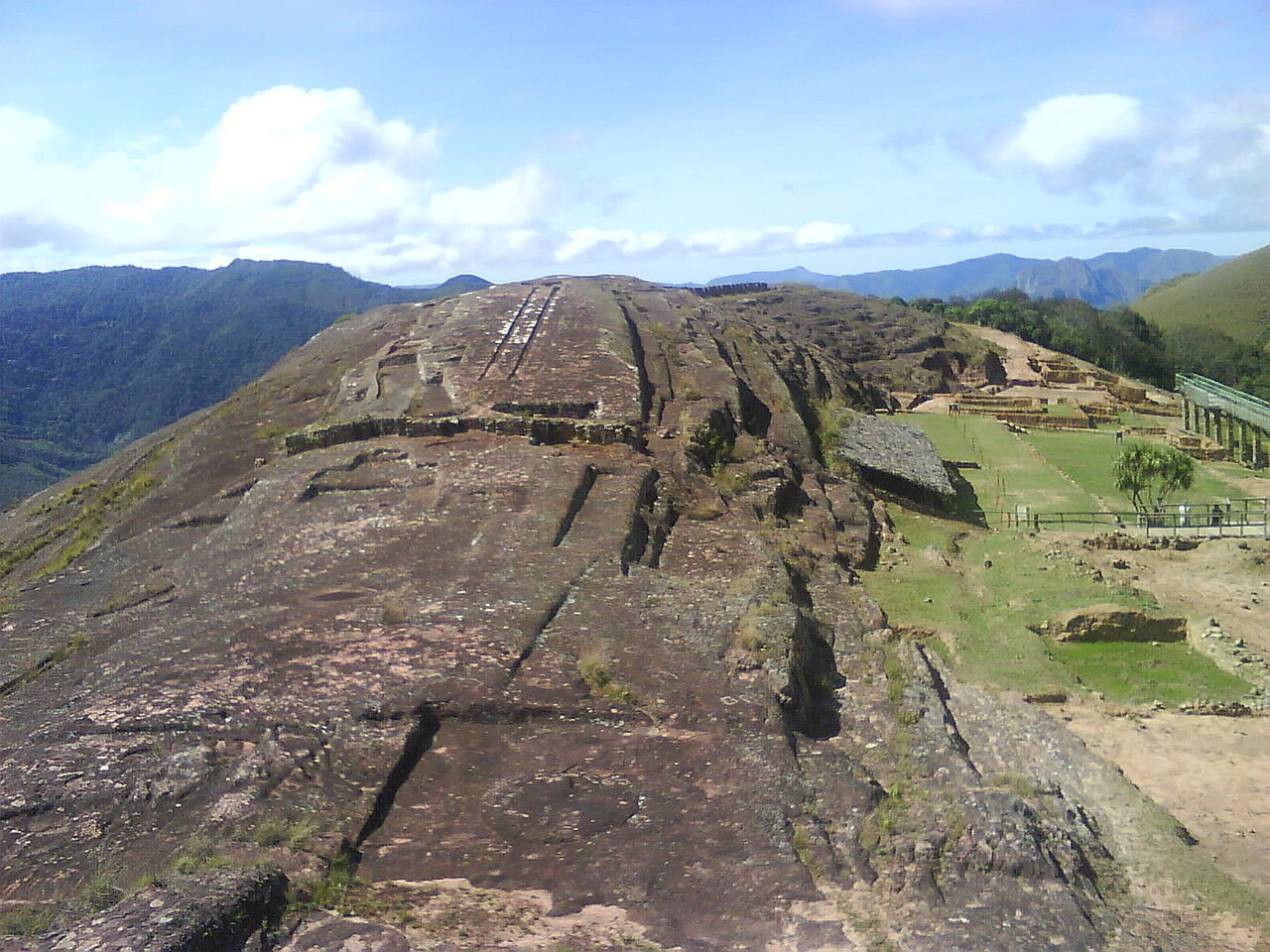 Massive carved sandstone rock outcrop of Fuerte de Samaipata Bolivia with niches and channels